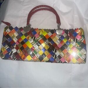 Nahui Ollin Multicolor Upcycled hand Bag with stunning Red Handles